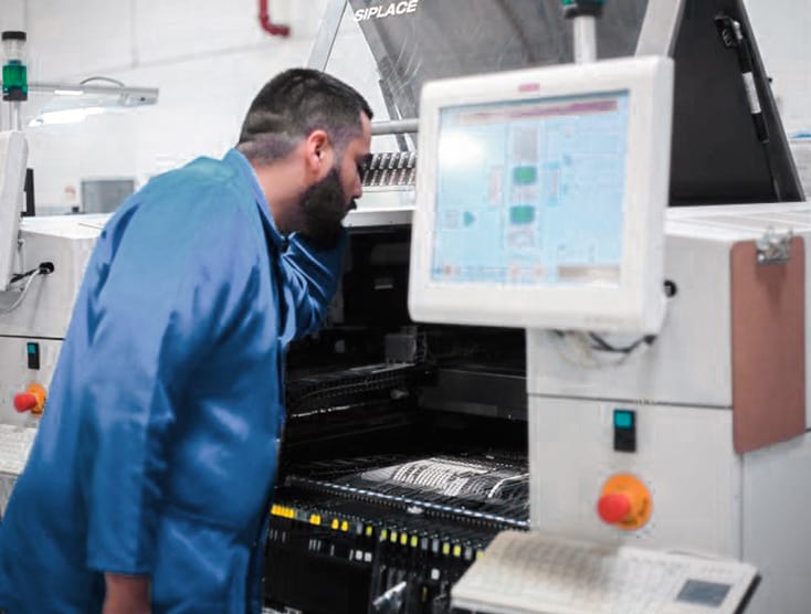 lab technician inspecting machine
